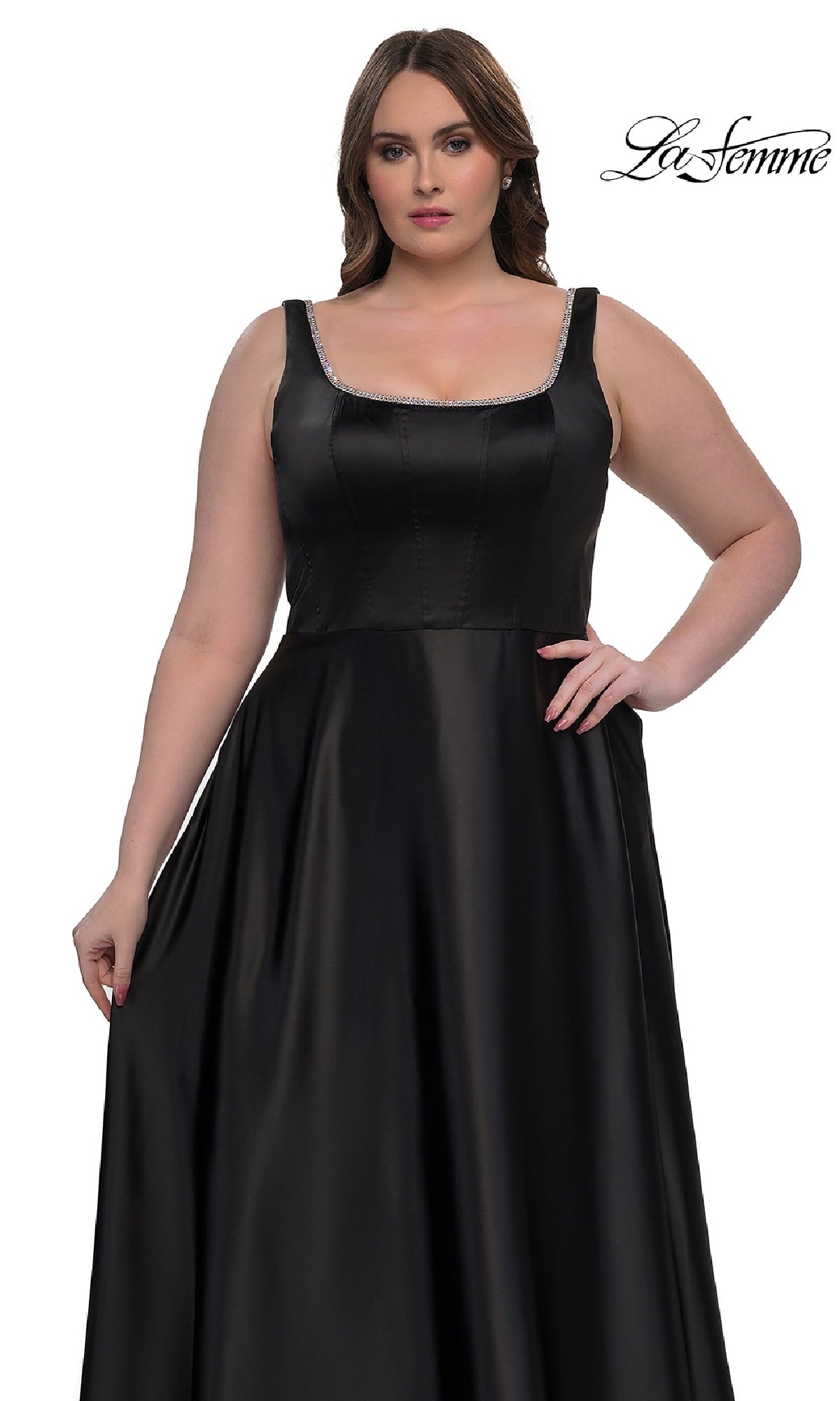 A woman models the Plus-Size Classic Long Prom Gown (La Femme 33026), a sleeveless black satin dress with a fitted bodice and flared skirt, against a white background. The